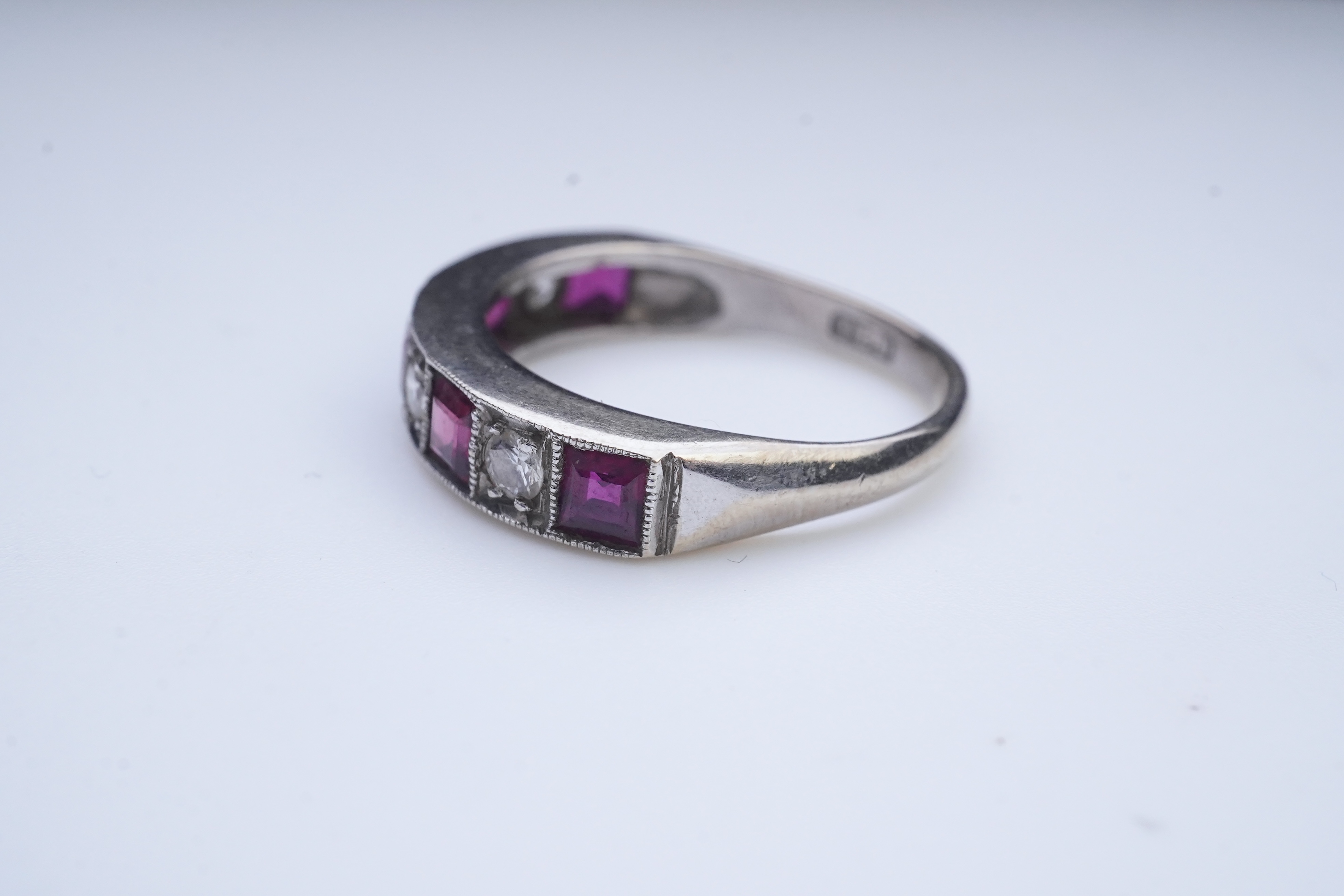 A ruby and diamond half eternity ring